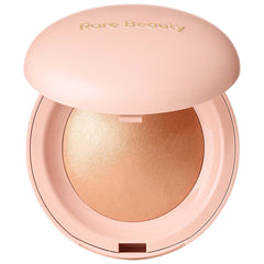 Compact powder with 'Rare Beauty' branding on a white background
