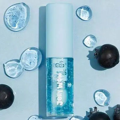 A blue-tinted lip gloss tube with water droplets and blueberries placed around it on a light blue background