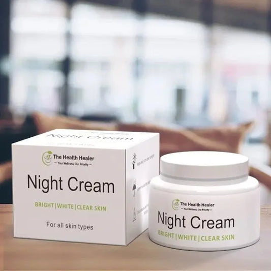 Night cream product displayed on a wooden surface with its box and jar labeled “Night Cream – Bright | White | Clear Skin” from The Health Healer, suitable for all skin types, in a softly blurred indoor background.