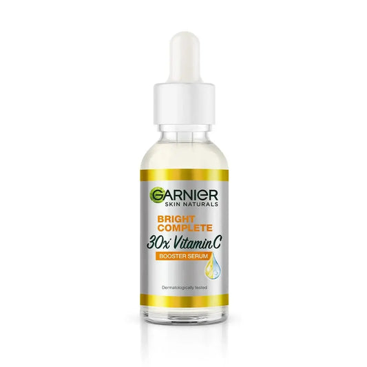 Garnier Skin Naturals Bright Complete 30x Vitamin C booster serum in a clear glass dropper bottle, designed to brighten skin and reduce dark spots.