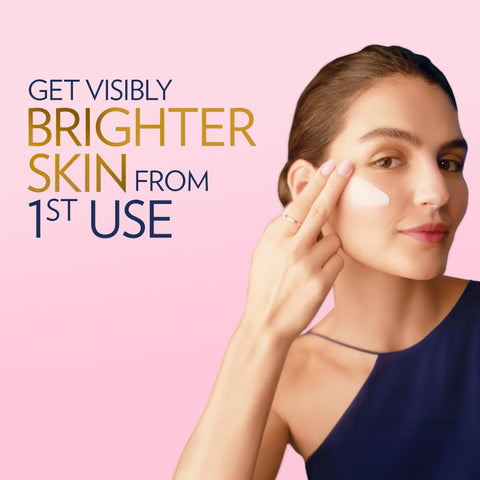 Woman applying cream to her face with text 'Get Visibly Brighter Skin from 1st Use' on a pink background