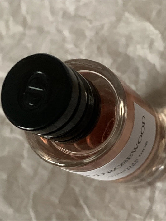 Bottle of oil with a black cap on a textured surface