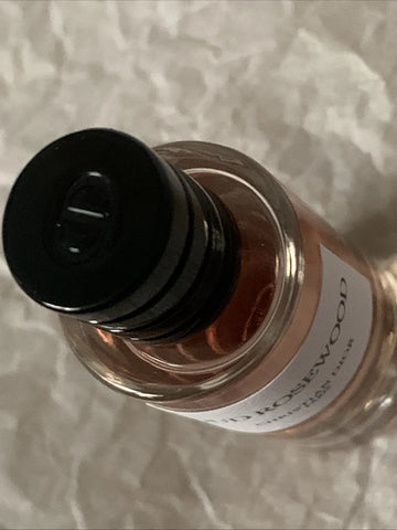 Bottle of oil with a black cap on a textured surface