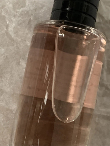 Clear bottle with black cap on a gray marble background